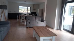 a living room with a couch and a table at Geevagh Holiday Home in Geevagh