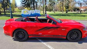 a red sports car parked in a parking lot at Gyula Panzio in Gyula