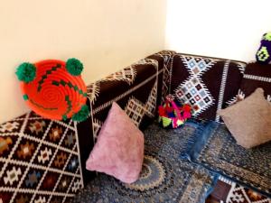 a couch with pillows on the floor next to a room at NiLe ViEW RANA NUbian Guest HOUES in Aswan