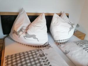 a bed with two pillows on it with at BergAufe Chalets Mallnitz in Mallnitz