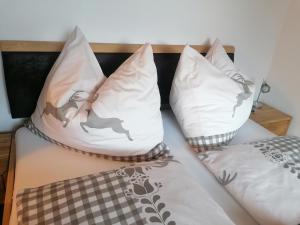 a bed with two pillows on it with at BergAufe Chalets Mallnitz in Mallnitz +81 photos