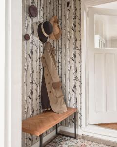 a coat and hat sitting on a bench next to a door at Gran Roble in Waupoos