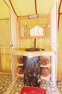 a bathroom with a sink and a mirror at Sunset luxury camp in Hassilabied +61 photos