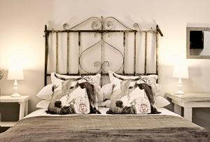 a bed with two cow pillows on it at Pumpkin Tree Guesthouse in Middelburg