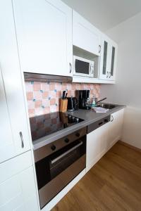A kitchen or kitchenette at Alpin Apartments