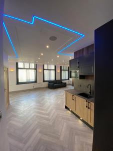 a large living room with blue lights on the ceiling at Eleanor Rigby apts Stanley Street in Liverpool
