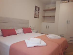 a bedroom with two beds with towels on them at Mirador del Río in Alcañiz