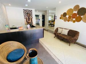 a lobby of a store with a chair and a couch at Hotel Retiro 84 in Bogotá