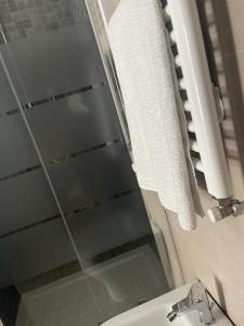 a bathroom with a glass shower and a toilet at Riviera Albachiara Anzio B&B in Anzio