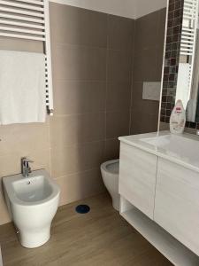 a bathroom with a sink and a toilet at Riviera Albachiara Anzio B&B in Anzio