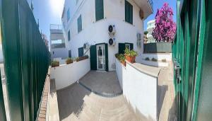 a hallway of a building with a door and flowers at Riviera Albachiara Anzio B&B in Anzio