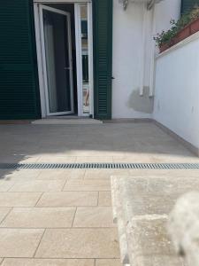 an entrance to a house with a door and a patio at Riviera Albachiara Anzio B&B in Anzio