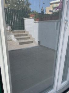 a view of a patio from a sliding glass door at Riviera Albachiara Anzio B&B in Anzio