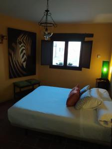 Schlafzimmer mit einem großen weißen Bett und einem Fenster in der Unterkunft Spa La Cueva del Agua in Hita