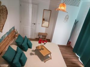 a living room with a table and green pillows at Beautiful beach in Santa Cruz de Tenerife