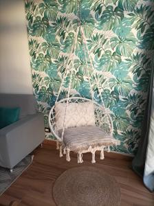 a wicker swing in a room with a wall at Beautiful beach in Santa Cruz de Tenerife