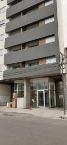 a tallartment building with a large glass door at Departamento Solares - San Martin in Bahía Blanca