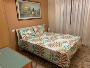 a bedroom with a bed and a couch in it at Villa LINA in Lido Di Fondi