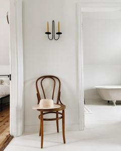 a chair and a table in a bathroom with a bath tub at Wild Rose in Picton