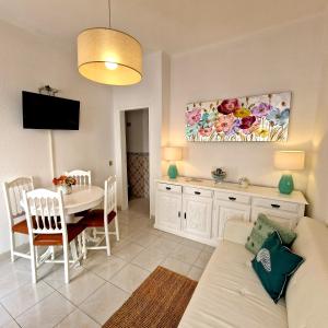 a living room and dining room with a couch and a table at Casa Alzira By ALzira in Albufeira
