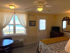a bedroom with a bed and a ceiling fan at Come from Away B&B in Digby