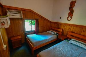 A bed or beds in a room at Gecko Hostel