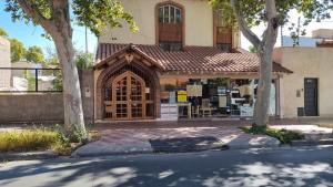 a building with a large wooden door on a street at NO ME OLVIDES in Mendoza