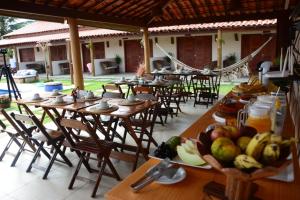a group of tables and chairs with fruit on them at Belladora Pousada in Barra Grande
