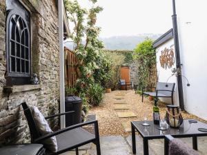 a patio with tables and chairs and a building at Siskin in Machynlleth