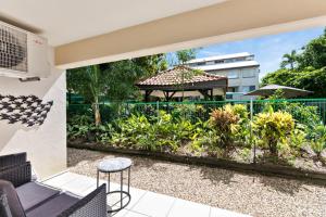 a patio with a view of a garden at Reef Gateway Apartments in Cairns