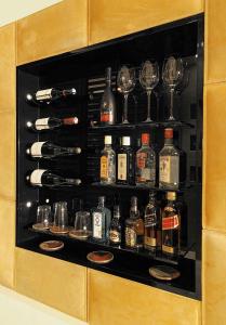 a display case with bottles and glasses of alcohol at DO&CO Hotel Vienna in Vienna