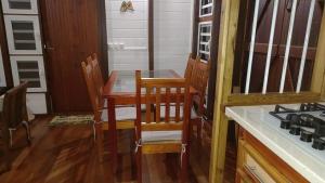 a kitchen with a table and chairs and a stove at Les Hauts de Bergette in Petit-Bourg