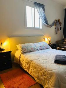 a bedroom with a large bed with a window at Charmant appartement au centre-ville de tanger in Tangier