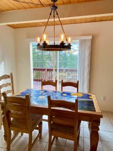 a dining room with a table and chairs and a chandelier at Bearvista in Arnold