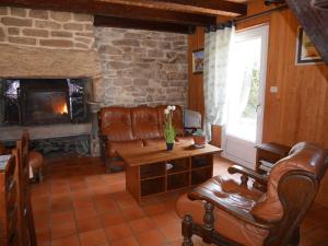 a living room with a couch and a fireplace at Granite stone house with fireplace, Plouguerneau in Plouguerneau