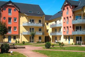 a row of apartment buildings in a park at Les Isles de Sola apartment in Grandcamp in Grandcamp-Maisy