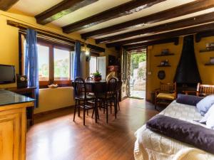 a bedroom with a table and chairs and a bed at Masia Can Constans in Queralbs