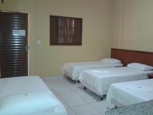 Ένα ή περισσότερα κρεβάτια σε δωμάτιο στο Hotel Veredas