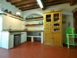 a large kitchen with a counter and a cabinet at Belvilla by OYO Podere San Giovanni ventisei in Chianni