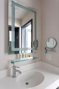 a bathroom with a sink and a mirror at Hotel EPIK in San Francisco