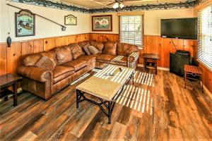 a living room with a leather couch and a flat screen tv at Frank's Old Bear-149 by Big Bear Vacations in Big Bear Lake