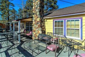 a group of chairs and tables on a patio at Frank's Old Bear-149 by Big Bear Vacations in Big Bear Lake