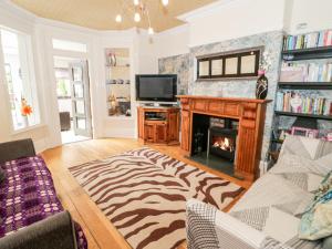 a living room with a zebra rug and a fireplace at Glendalough in Colwyn Bay