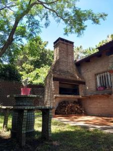 a brick fireplace in front of a house at Las Calandrias in Funes