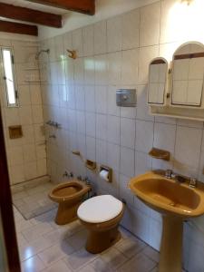 a bathroom with a toilet and a sink at Las Calandrias in Funes