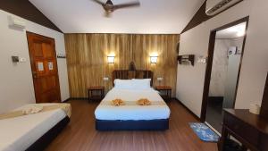 A bed or beds in a room at Bilit Adventure Lodge