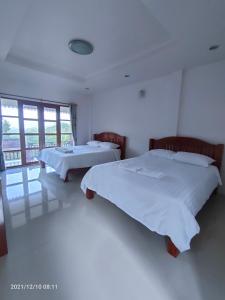 Postel nebo postele na pokoji v ubytování Inpai Resort อินปายรีสอร์ท
