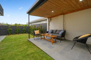 a patio with a table and chairs in a yard at Comfort & Style - Luxurious Central Apartment in Albury