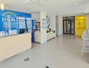 a store lobby with a hore pharmacy with a counter and chairs at Hop Inn Mahasarakham in Maha Sarakham