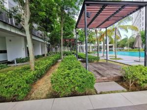 a courtyard with a pool and a wooden walkway at G-mat Staycation free WiFi & Netflix in Cyberjaya